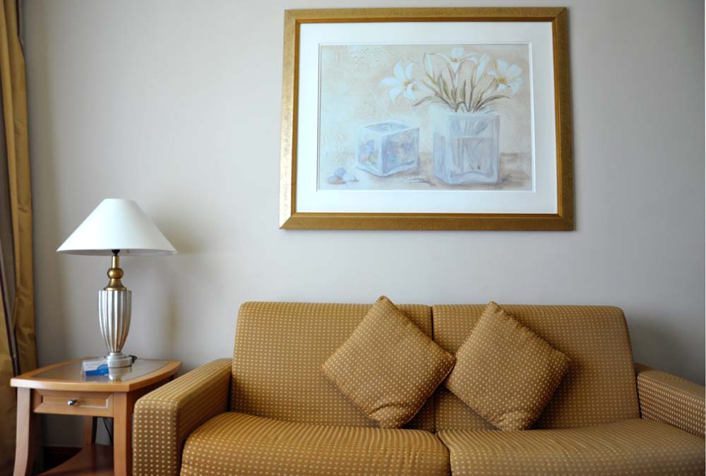 a large wall painting art above a sofa