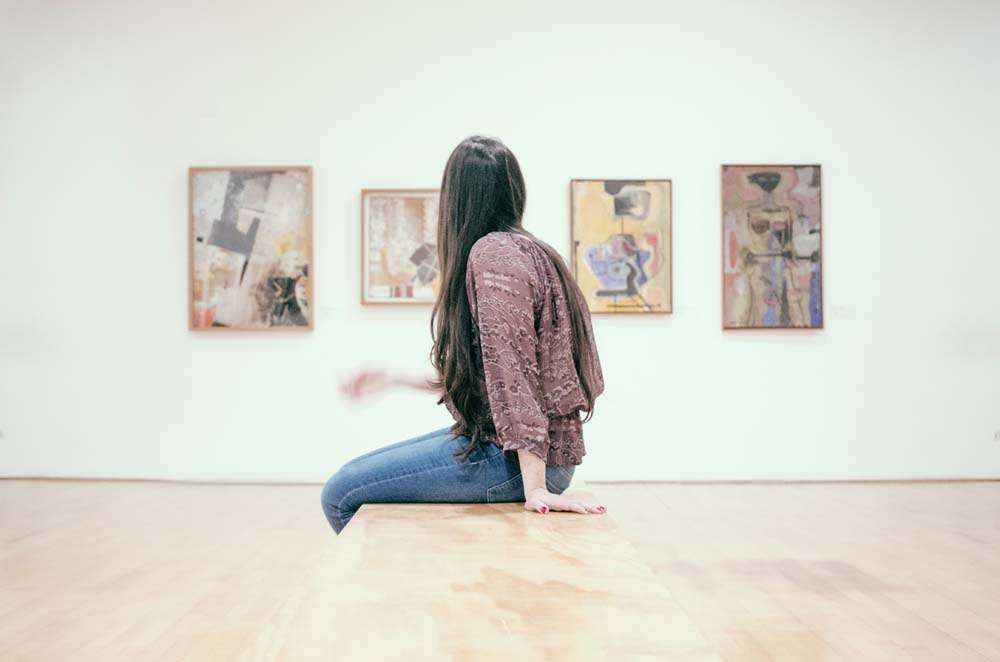 a woman viewing wall arts