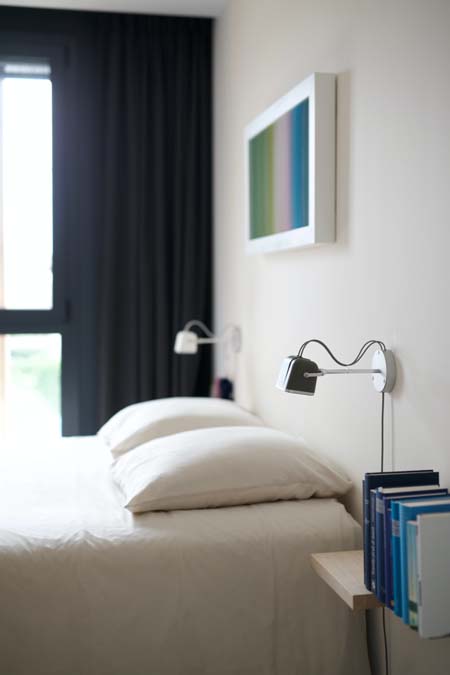 a bedroom with a calm abstract wall art