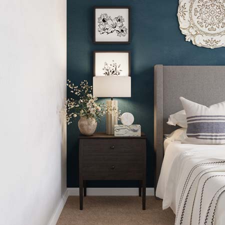 hang 2 pictures vertically above the nightstand